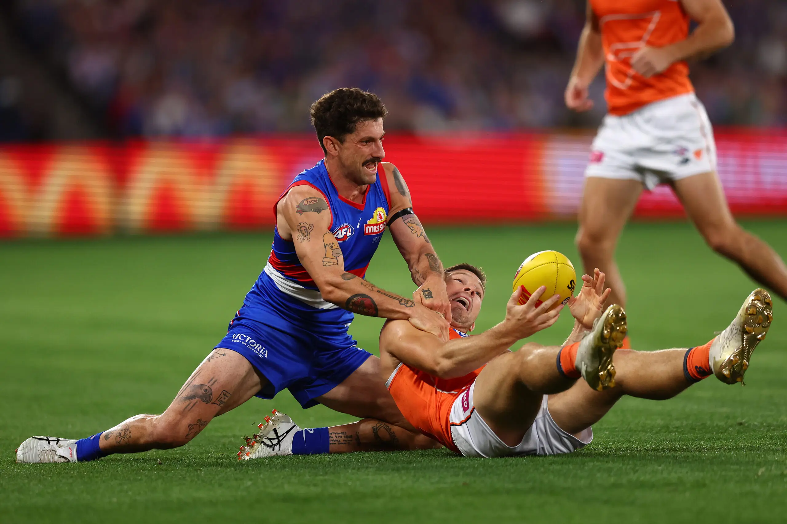 MELBOURNE, AUSTRALIA - MARCH 14: Tom Liberatore of the Bulldogs (L) tackles Toby Greene of the Giants during the round one AFL match between Western Bulldogs and Greater Western Sydney Giants at Marvel Stadium on March 14, 2026 in Melbourne, Australia. (Photo by Graham Denholm/Getty Images)