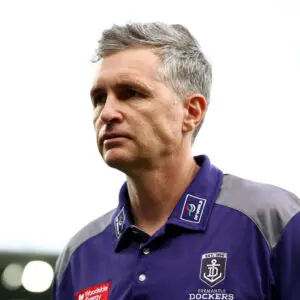GEELONG, AUSTRALIA - MARCH 14: Justin Longmuir, Senior Coach of the Dockers looks dejected after losing the round one AFL match between Geelong Cats and Fremantle Dockers at GMHBA Stadium, on March 14, 2026, in Geelong, Australia. (Photo by Josh Chadwick/Getty Images)