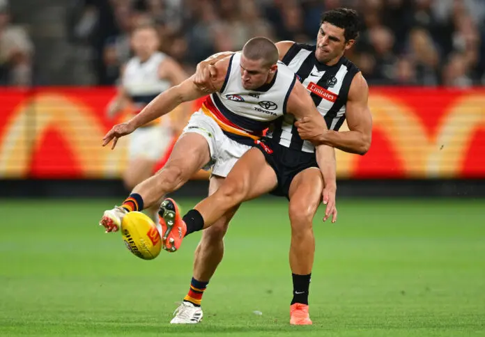 MELBOURNE, AUSTRALIA - MARCH 14: Sam Berry of the Crows kicks whilst being tackled by Scott Pendlebury of the Magpies during the round one AFL match between Collingwood Magpies and Adelaide Crows at Melbourne Cricket Ground, on March 14, 2026, in Melbourne, Australia. (Photo by Quinn Rooney/Getty Images)