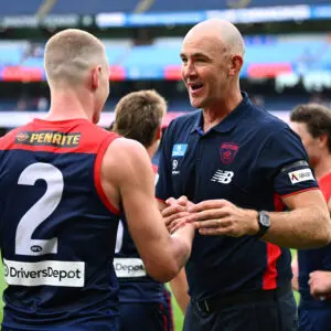 MELBOURNE, AUSTRALIA - MARCH 15: Steven King, Senior Coach of the Demons and Jacob van Rooyen of the Demons celebrate winning the round one AFL match between Melbourne Demons and St Kilda Saints at Melbourne Cricket Ground, on March 15, 2026, in Melbourne, Australia. (Photo by Quinn Rooney/Getty Images)
