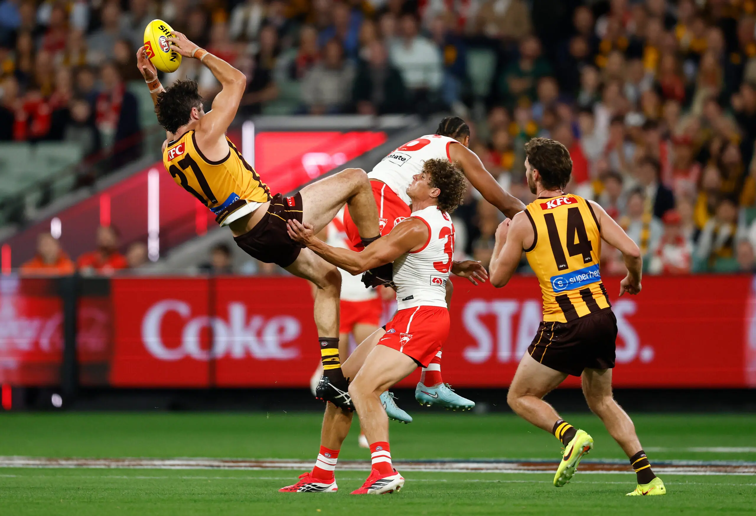 MELBOURNE, AUSTRALIA - MARCH 19: Tom Barrass of the Hawks marks the ball over Joel Amartey of the Swans as Charlie Curnow of the Swans and Jack Scrimshaw of the Hawks look on during the 2026 AFL Round 02 match between the Hawthorn Hawks and the Sydney Swans at the Melbourne Cricket Ground on March 19, 2026 in Melbourne, Australia. (Photo by Michael Willson/AFL Photos via Getty Images)