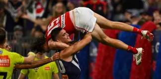 New-look Dees handed the heave-ho by ominously slick Dockers PERTH, AUSTRALIA - MARCH 21: Patrick Voss of the Dockers picks up and carries Ed Langdon of the Demons on his shoulder during the 2026 AFL Round 02 match between the Fremantle Dockers and the Melbourne Demons at Optus Stadium on March 21, 2026 in Perth, Australia. (Photo by Daniel Carson/AFL Photos via Getty Images)