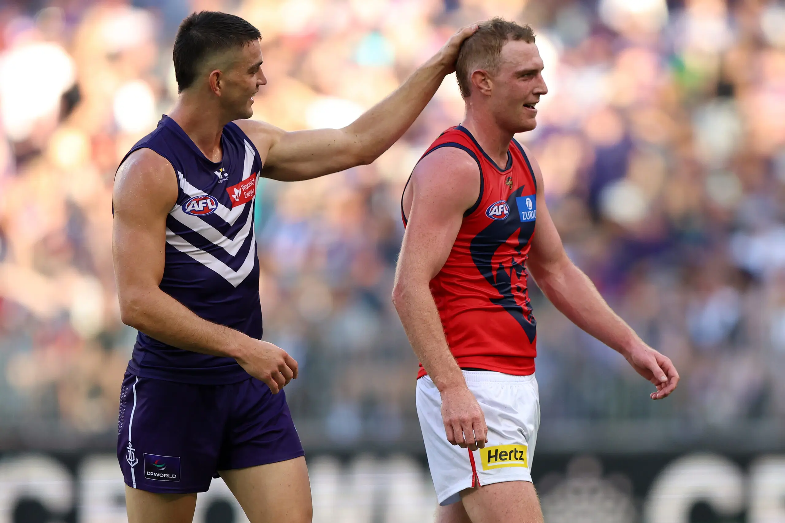 PERTH, AUSTRALIA - MARCH 21: Patrick Voss of the Dockers taunts Harrison Petty of the Demons during the round two AFL match between Fremantle Dockers and Melbourne Demons at Optus Stadium, on March 21, 2026, in Perth, Australia. (Photo by Janelle St Pierre/AFL Photos/via Getty Images)