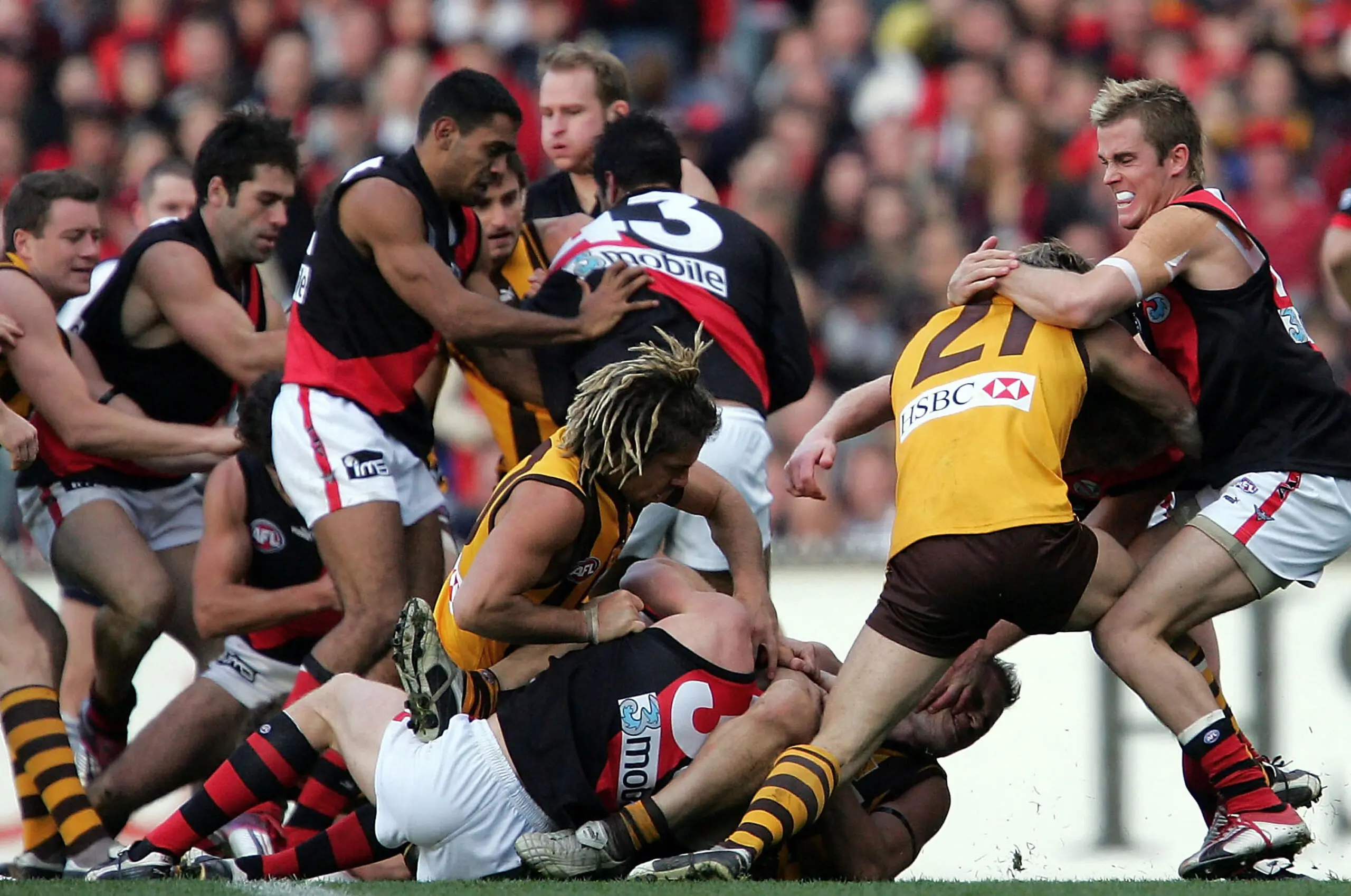 MELBOURNE, AUSTRALIA - JUNE 5: Bombers and Hawks players clash during the round eleven AFL match between The Hawthorn Hawks and the The Essendon Bombers at the M.C.G. on June 5, 2004 in Melbourne, Australia. (Photo by Ryan Pierse/Getty Images)