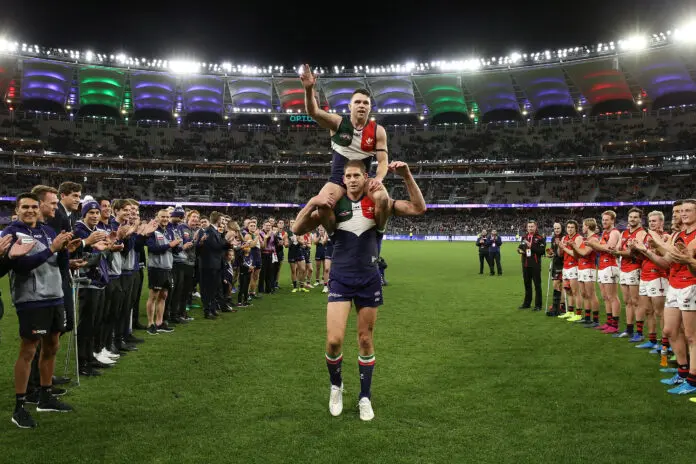 PERTH, AUSTRALIA - AUGUST 17: Aaron Sandilands of the Dockers carries Hayden Ballantyne thru a guard of honour after playing their final games for the club during the round 22 AFL match between the Fremantle Dockers and the Essendon Bombers at Optus Stadium on August 17, 2019 in Perth, Australia. (Photo by Paul Kane/Getty Images)