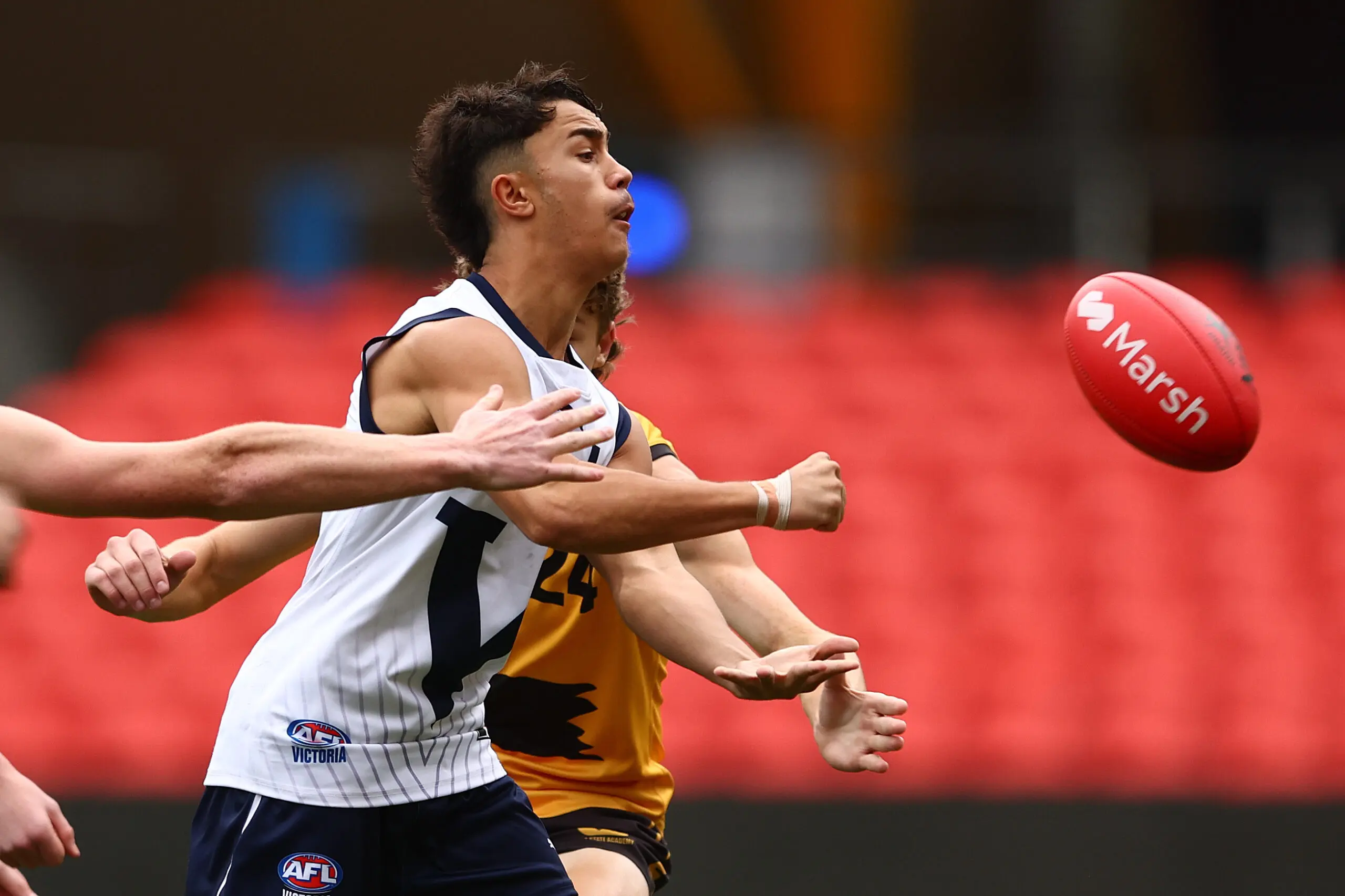GOLD COAST, AUSTRALIA - JULY 09: Marcus Prasad of Victoria Country handballs during the Marsh AFL National Championships match between U16 Boys Victoria Country and Western Australia at People First Stadium on July 09, 2024 in Gold Coast, Australia. (Photo by Chris Hyde/AFL Photos/via Getty Images)