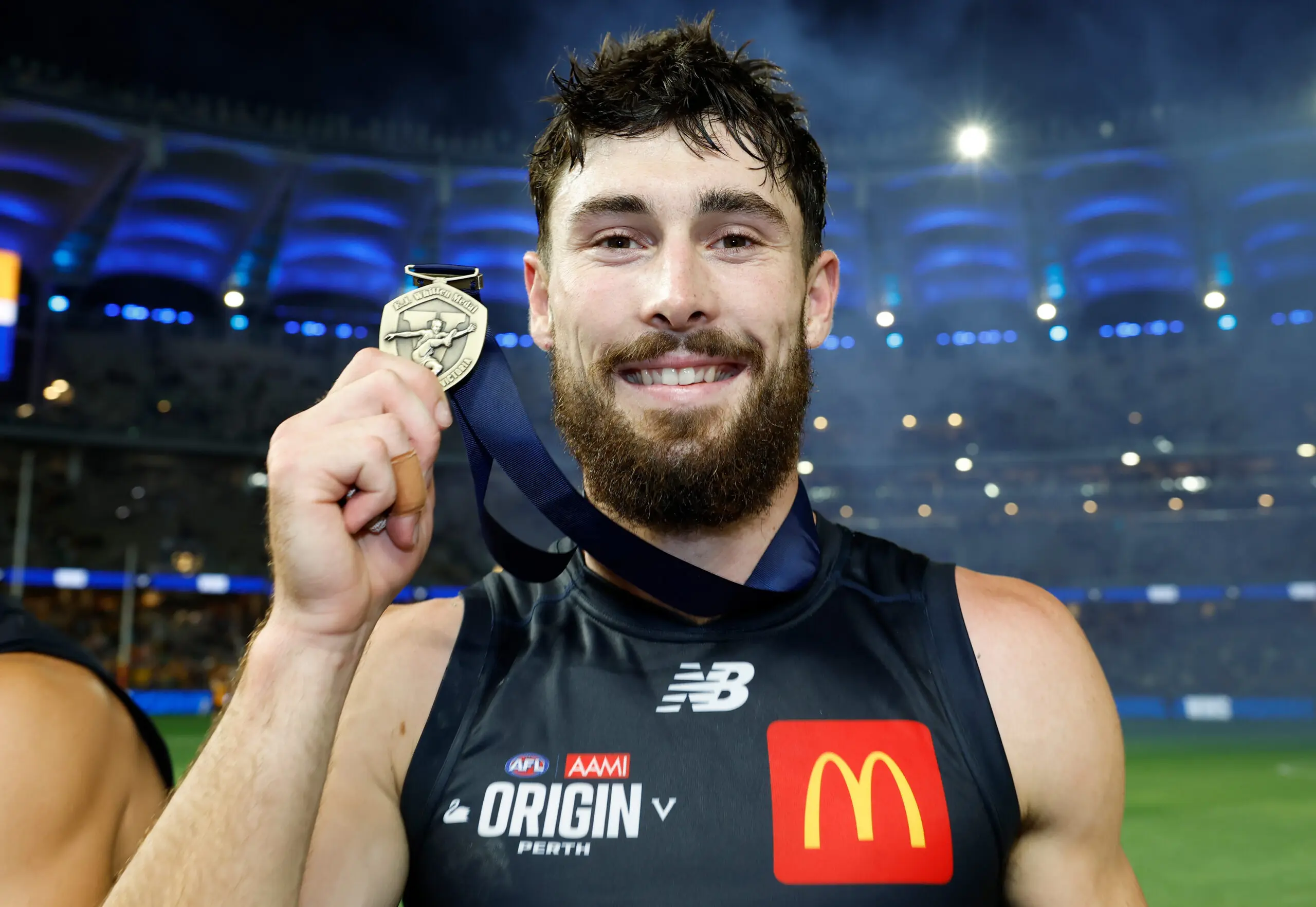 PERTH, AUSTRALIA - FEBRUARY 14: Lachie Ash of Victoria poses with the EJ Whitten Medal during the 2026 AFL Origin match between Western Australia and Victoria at Optus Stadium on February 14, 2026 in Perth, Australia. (Photo by Michael Willson/AFL Photos via Getty Images)