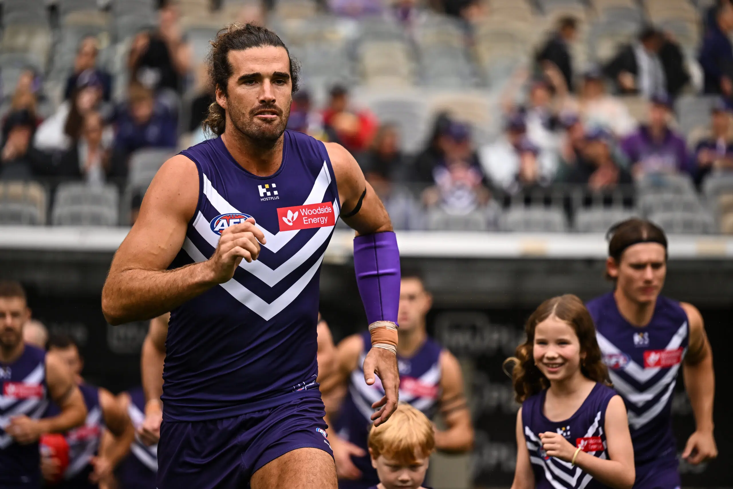 PERTH, AUSTRALIA - MARCH 28: Alex Pearce of the Dockers enters the field during the 2026 AFL Round 03 match between the Fremantle Dockers and the Richmond Tigers at Optus Stadium on March 28, 2026 in Perth, Australia. (Photo by Daniel Carson/AFL Photos via Getty Images)