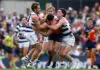 ADELAIDE, AUSTRALIA - APRIL 12: Liam Duggan of the Eagles is tackled by Tom Atkins (left) and Gryan Miers of the Cats during the 2026 AFL Round 05 match between the Geelong Cats and the West Coast Eagles at Norwood Oval on April 12, 2026 in Adelaide, Australia. (Photo by Michael Willson/AFL Photos via Getty Images)