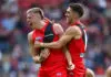 ADELAIDE, AUSTRALIA - APRIL 11: Nate Caddy of the Bombers is congratulated by Jade Gresham of the Bombers after kicking a goal during the round five AFL match between Essendon Bombers and Melbourne Demons at Adelaide Oval, on April 11, 2026, in Adelaide, Australia. (Photo by Quinn Rooney/Getty Images)
