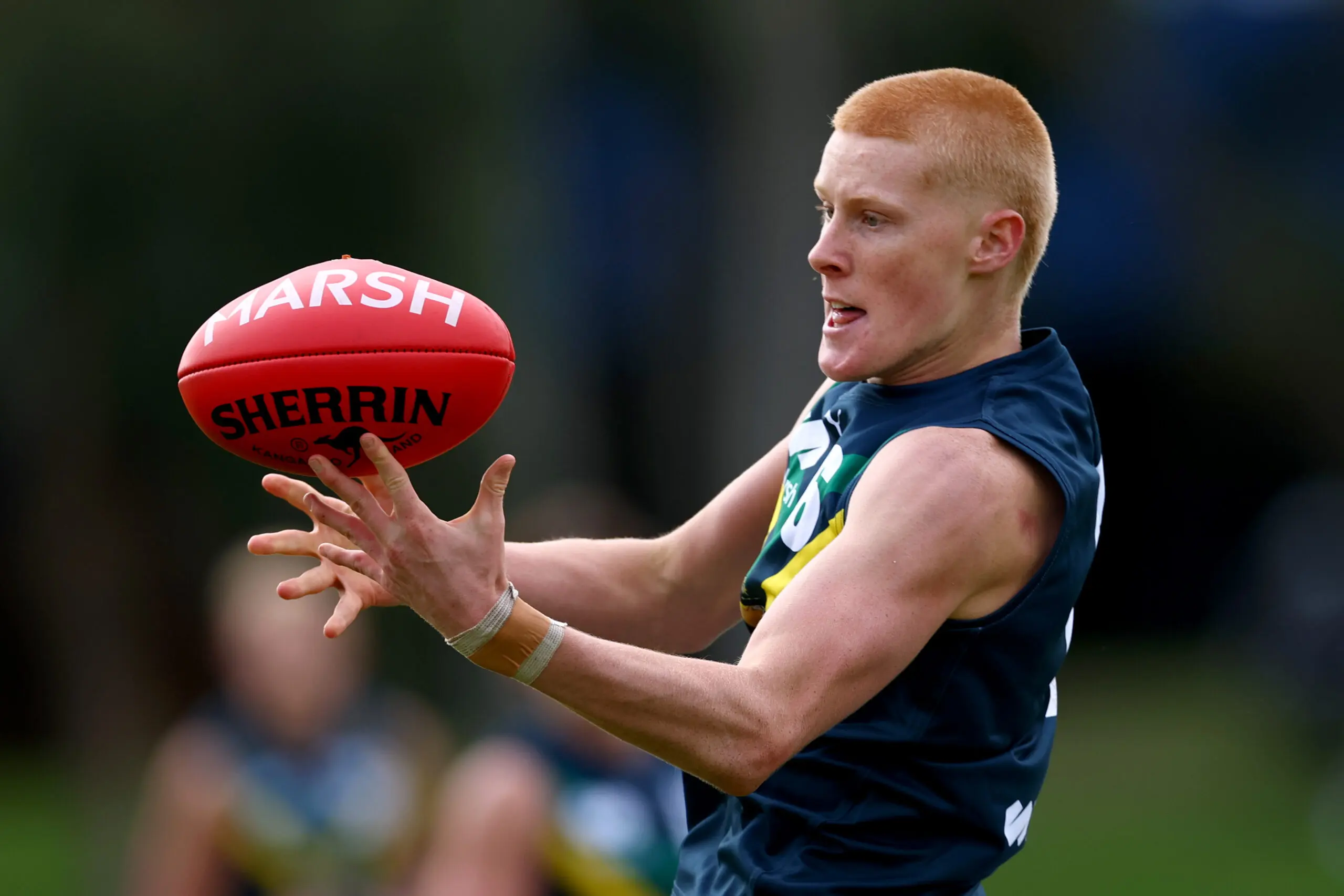 MELBOURNE, AUSTRALIA - APRIL 12: Gabriel Patterson of the AFL National Academy marks infront of Hugo Mikunda of the Kangaroos during the Marsh AFL National Academy Boys match between Australia U18 and North Melbourne VFL at Arden Street Ground on April 12, 2026 in Melbourne, Australia. (Photo by Josh Chadwick/AFL Photos/via Getty Images)