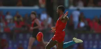“Like chook lotto”: Suns coach frustrated over umpire calls GOLD COAST, AUSTRALIA - APRIL 18: Touk Miller of the Suns kicks during the round six AFL match between Gold Coast Suns and Essendon Bombers at People First Stadium, on April 18, 2026, in Gold Coast, Australia. (Photo by Chris Hyde/Getty Images)