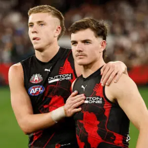 MELBOURNE, AUSTRALIA - APRIL 25: Nate Caddy (left) and Archie Roberts of the Bombers look dejected after a loss during the 2026 AFL Round 07 match between the Essendon Bombers and the Collingwood Magpies at the Melbourne Cricket Ground on April 25, 2026 in Melbourne, Australia. (Photo by Michael Willson/AFL Photos via Getty Images)