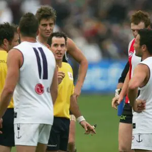LAUNCESTON, TAS - APRIL 30:  Umpire Hayden Kennedy talks to Fremantle players about not hearing the final siren after the round five AFL match between the St Kilda Saints and the Fremantle Dockers at Aurora Stadium April 30, 2006 in Launceston, Australia.    (Photo by Sean Garnsworthy/Getty Images)
