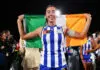 MELBOURNE, AUSTRALIA - NOVEMBER 29: Blaithin Bogue of the Kangaroos poses with an Iris flag after winning the AFLW Grand Final match between North Melbourne Kangaroos and Brisbane Lions at Ikon Park on November 29, 2025 in Melbourne, Australia. (Photo by Daniel Pockett/Getty Images)