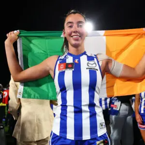 MELBOURNE, AUSTRALIA - NOVEMBER 29: Blaithin Bogue of the Kangaroos poses with an Iris flag after winning the AFLW Grand Final match between North Melbourne Kangaroos and Brisbane Lions at Ikon Park on November 29, 2025 in Melbourne, Australia. (Photo by Daniel Pockett/Getty Images)