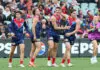 ADELAIDE, AUSTRALIA - APRIL 11: Brody Mihocek of the Demons celebrates a goal with team mates during the 2026 AFL Round 05 match between the Essendon Bombers and the Melbourne Demons at Adelaide Oval on April 11, 2026 in Adelaide, Australia. (Photo by Sarah Reed/AFL Photos via Getty Images)