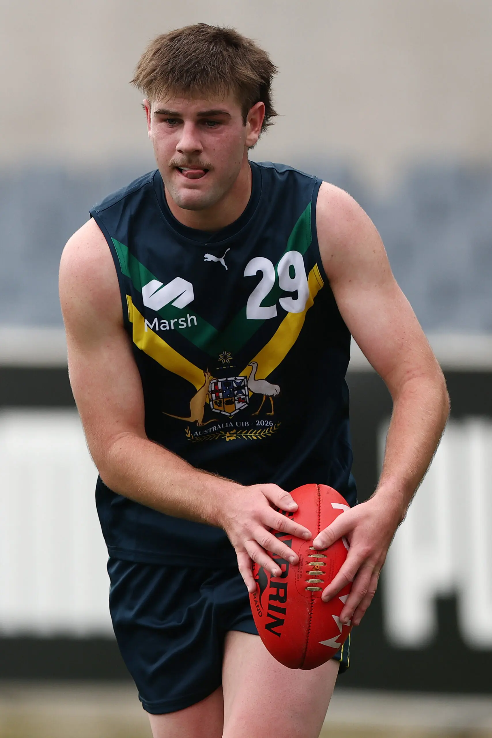 MELBOURNE, AUSTRALIA - APRIL 18: Tate Hodgson of the AFL National Academy takes possession of the ball during the Marsh AFL National Academy Boys match between Australia U18 and Richmond VFL at Ikon Park on April 18, 2026 in Melbourne, Australia. (Photo by Morgan Hancock/AFL Photos/via Getty Images)