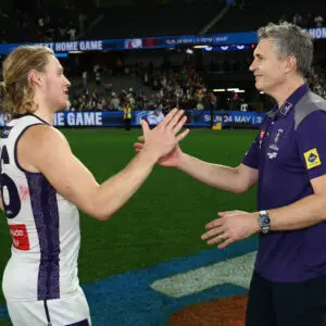 MELBOURNE, AUSTRALIA - MAY 01: Hayden Young and Justin Longmuir, Senior Coach of the Dockers embrace during the 2026 AFL Round 08 match between the Western Bulldogs and the Fremantle Dockers at Marvel Stadium on May 1, 2026 in Melbourne, Australia. (Photo by James Wiltshire/AFL Photos via Getty Images)