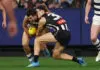 MELBOURNE, AUSTRALIA - MAY 09: Oisin Mullin of the Cats and Darcy Moore of the Magpies clash heads during the round nine AFL match between Geelong Cats and Collingwood Magpies at Melbourne Cricket Ground, on May 09, 2026, in Melbourne, Australia. (Photo by Morgan Hancock/AFL Photos/via Getty Images)