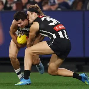 MELBOURNE, AUSTRALIA - MAY 09: Oisin Mullin of the Cats and Darcy Moore of the Magpies clash heads during the round nine AFL match between Geelong Cats and Collingwood Magpies at Melbourne Cricket Ground, on May 09, 2026, in Melbourne, Australia. (Photo by Morgan Hancock/AFL Photos/via Getty Images)