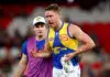 MELBOURNE, AUSTRALIA - MAY 10: Harry Edwards of the Eagles is assisted off the ground under the blood rule during the round nine AFL match between Melbourne Demons and West Coast Eagles at Marvel Stadium, on May 10, 2026, in Melbourne, Australia. (Photo by Josh Chadwick/Getty Images)
