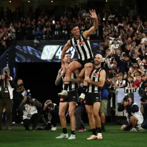 MELBOURNE, AUSTRALIA - MAY 23: Scott Pendlebury of the Magpies chaired off by Steele Sidebottom and Jeremy Howe during the 2026 AFL Round 11 match between the Collingwood Magpies and Waalitj Marawar (West Coast Eagles) at the Melbourne Cricket Ground on May 23, 2026 in Melbourne, Australia. (Photo by James Wiltshire/AFL Photos via Getty Images)
