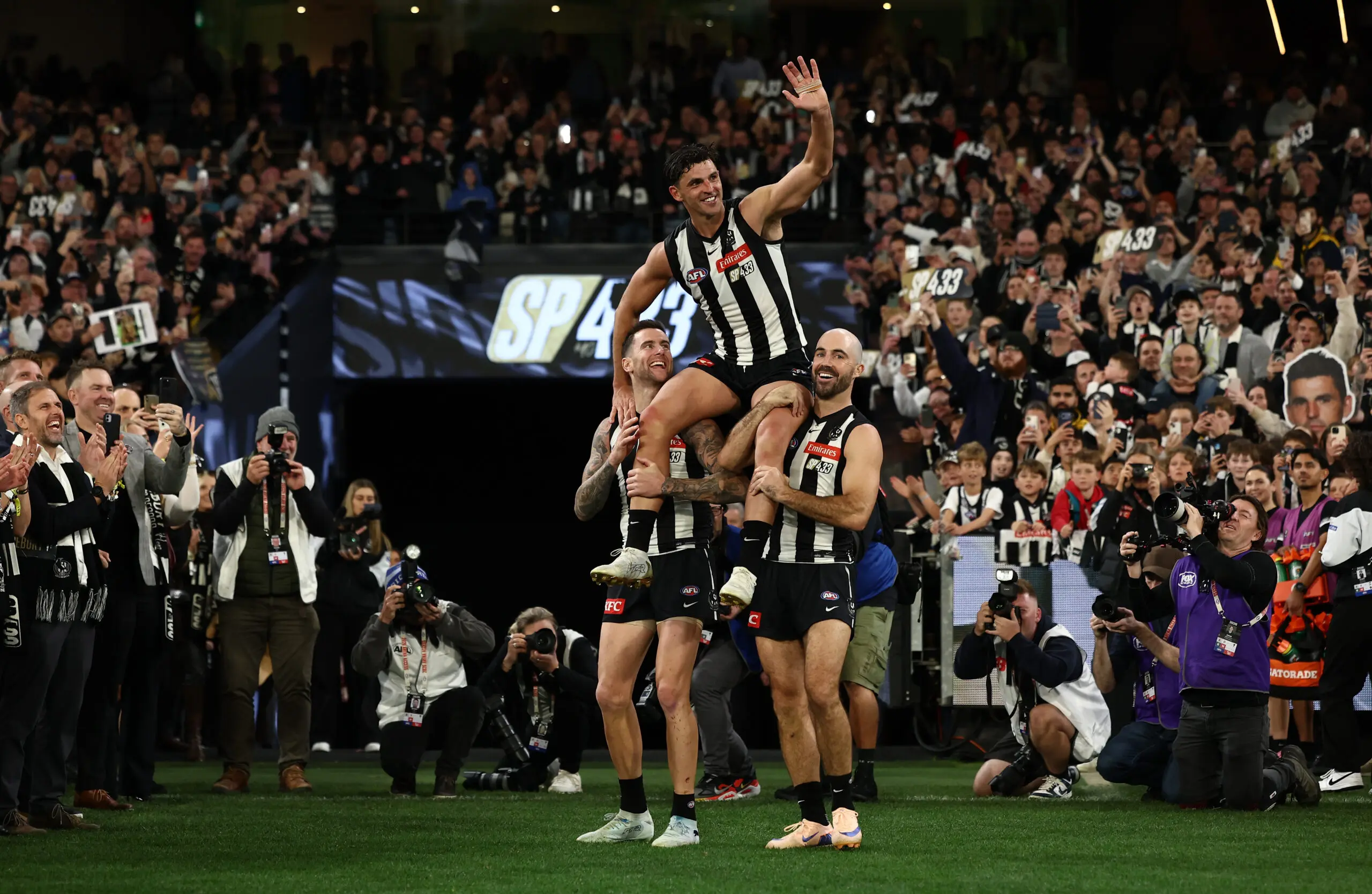 MELBOURNE, AUSTRALIA - MAY 23: Scott Pendlebury of the Magpies chaired off by Steele Sidebottom and Jeremy Howe during the 2026 AFL Round 11 match between the Collingwood Magpies and Waalitj Marawar (West Coast Eagles) at the Melbourne Cricket Ground on May 23, 2026 in Melbourne, Australia. (Photo by James Wiltshire/AFL Photos via Getty Images)