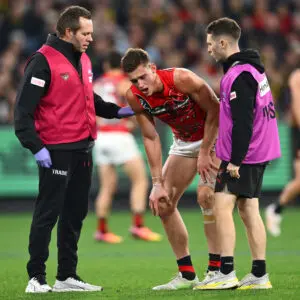 MELBOURNE, AUSTRALIA - MAY 22: Archer May of the Bombers is helped from the ground by trainers during the round 11 AFL match between Richmond Tigers and Essendon Bombers at Melbourne Cricket Ground, on May 22, 2026, in Melbourne, Australia. (Photo by Quinn Rooney/Getty Images)