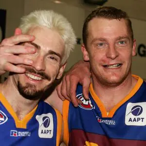 MELBOURNE, AUSTRALIA - SEPTEMBER 18:  Jason Akermanis #12 and Michael Voss #3 for the Lions celebrate after winning the AFL Second Preliminary Final match between the Brisbane Lions and the Geelong Cats at the Melbourne Cricket Ground September 18 2004 in Melbourne, Australia. (Photo by Mark Dadswell/Getty Images)