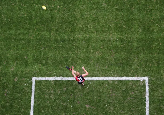 MELBOURNE, AUSTRALIA - FEBRUARY 20: Dustin Fletcher #31 for the Bombers kicks out during the round one AFL Wizard Cup match between the Carlton Blues and the Essendon Bombers at the Telstra Dome on February 20, 2004 in Melbourne, Australia. (Photo by Ryan Pierse/Getty Images)