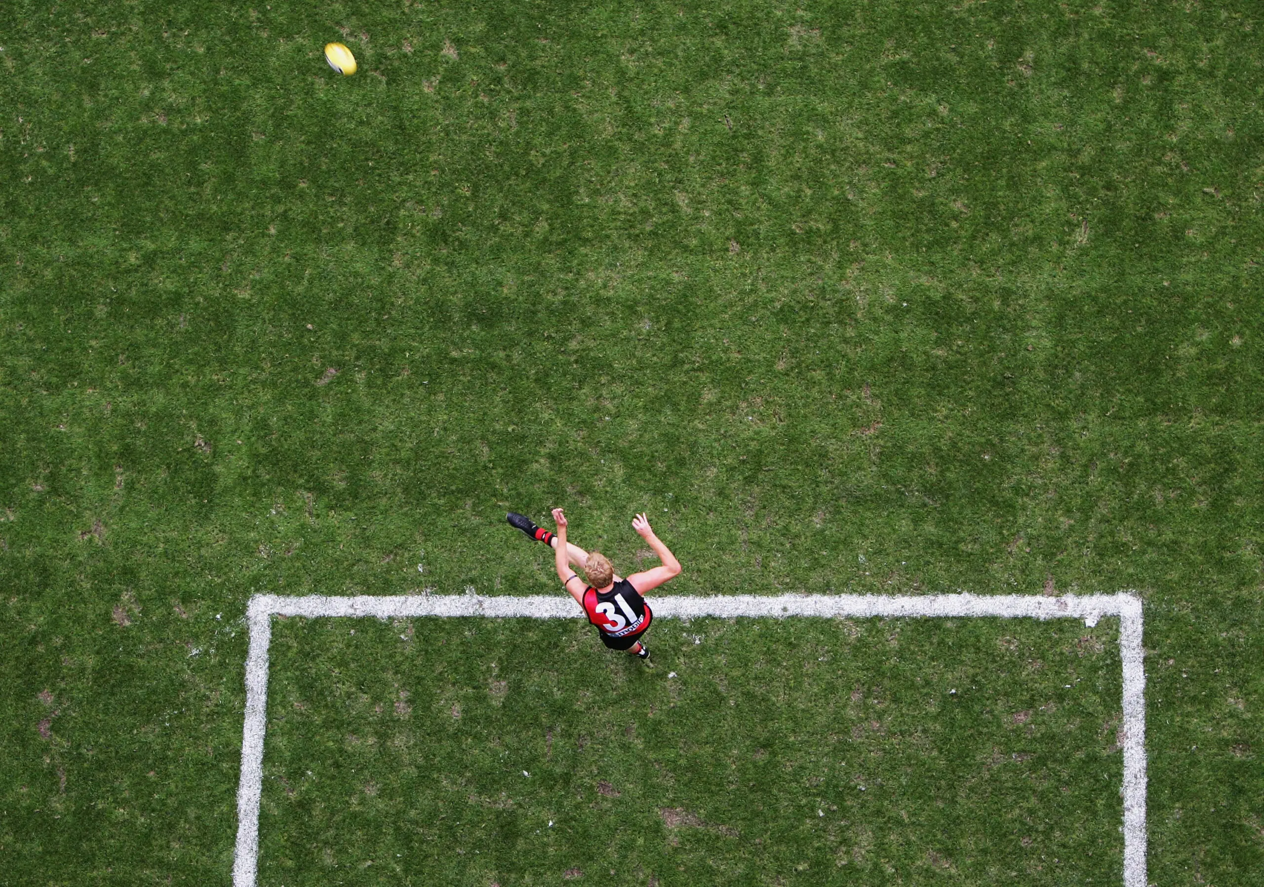 MELBOURNE, AUSTRALIA - FEBRUARY 20: Dustin Fletcher #31 for the Bombers kicks out during the round one AFL Wizard Cup match between the Carlton Blues and the Essendon Bombers at the Telstra Dome on February 20, 2004 in Melbourne, Australia. (Photo by Ryan Pierse/Getty Images)