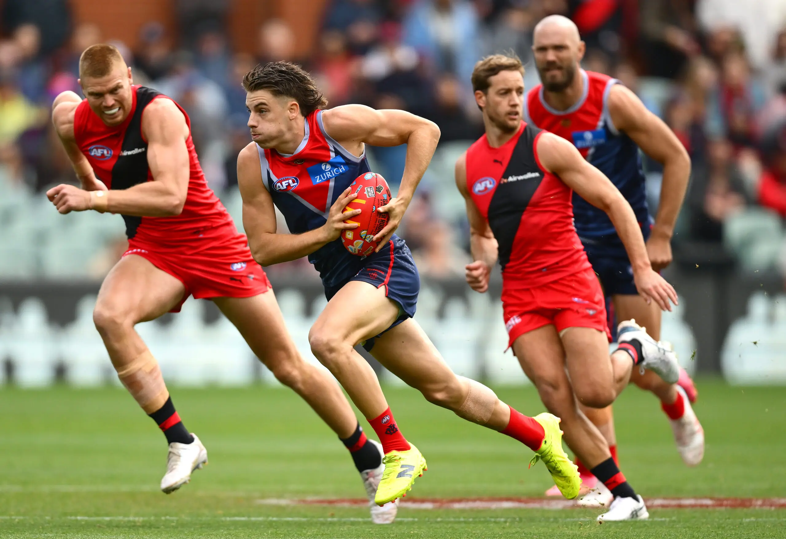 ADELAIDE, AUSTRALIA - APRIL 11: Caleb Windsor of the Demons clears the ball from the centre during the round five AFL match between Essendon Bombers and Melbourne Demons at Adelaide Oval, on April 11, 2026, in Adelaide, Australia. (Photo by Quinn Rooney/Getty Images)