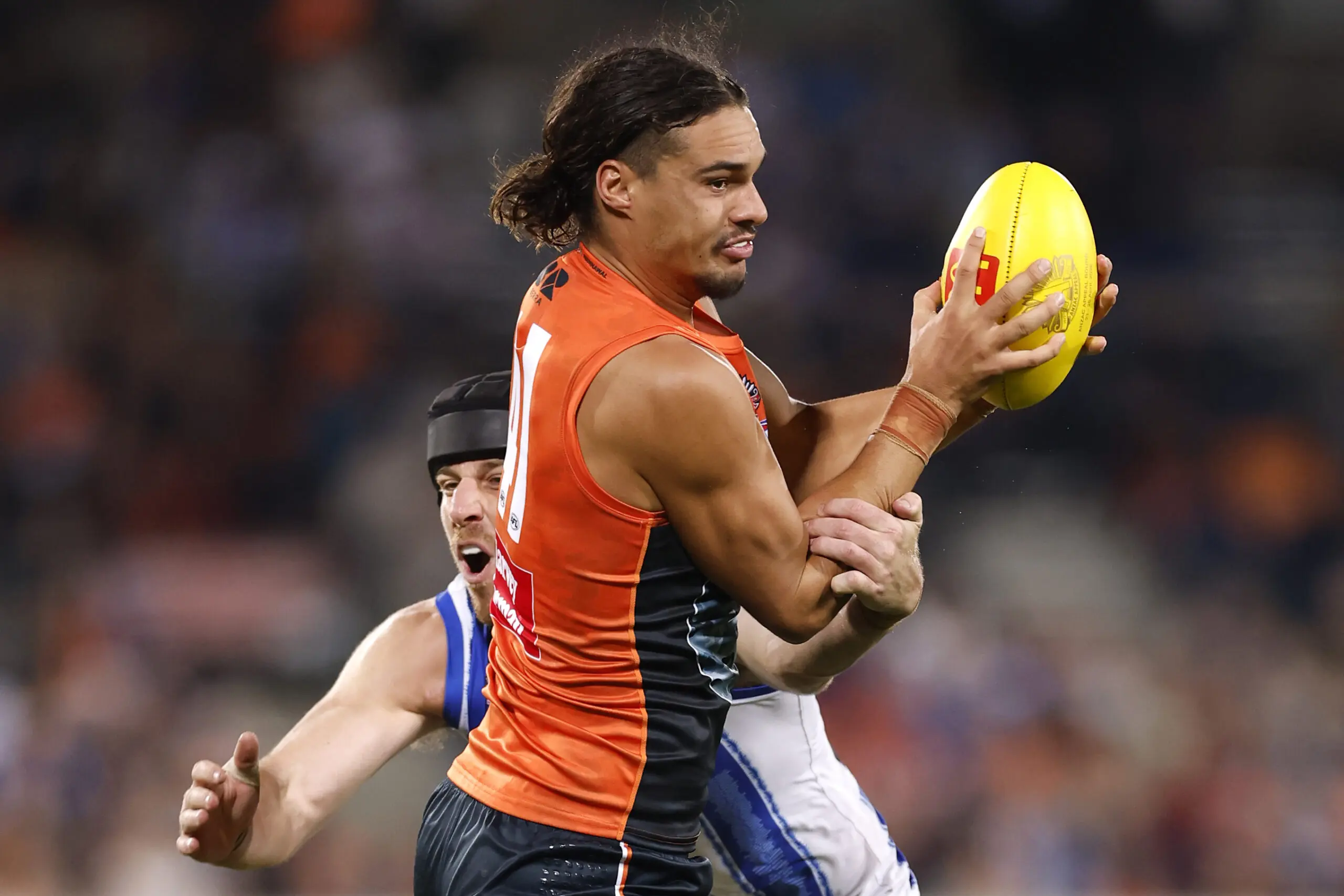 CANBERRA, AUSTRALIA - APRIL 26: Nicholas Madden of the Giants is tackled by Tristan Xerri of the Kangaroos during the round seven AFL match between Greater Western Sydney Giants and North Melbourne Kangaroos at Manuka Oval, on April 26, 2026, in Canberra, Australia. (Photo by Darrian Traynor/Getty Images)
