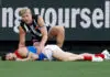 MELBOURNE, AUSTRALIA - JUNE 08: Brody Mihocek of the Demons lays injured as Billy Frampton of the Magpies looks on during the 2026 AFL Round 13 match between the Collingwood Magpies and the Melbourne Demons at the Melbourne Cricket Ground on June 8, 2026 in Melbourne, Australia. (Photo by Michael Willson/AFL Photos via Getty Images)