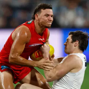 GEELONG, AUSTRALIA - JUNE 12: Daniel Rioli of the Suns is tackled by Shaun Mannagh of the Cats during the 2026 AFL Round 14 match between the Geelong Cats and the Gold Coast Suns at GMHBA Stadium on June 12, 2026 in Geelong, Australia. (Photo by Michael Willson/AFL Photos via Getty Images)