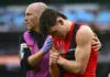 MELBOURNE, AUSTRALIA - JUNE 13: Archie Roberts of the Bombers is helped from the ground by trainers during the round 14 AFL match between Melbourne Demons and Essendon Bombers at Melbourne Cricket Ground, on June 13, 2026, in Melbourne, Australia. (Photo by Quinn Rooney/Getty Images)
