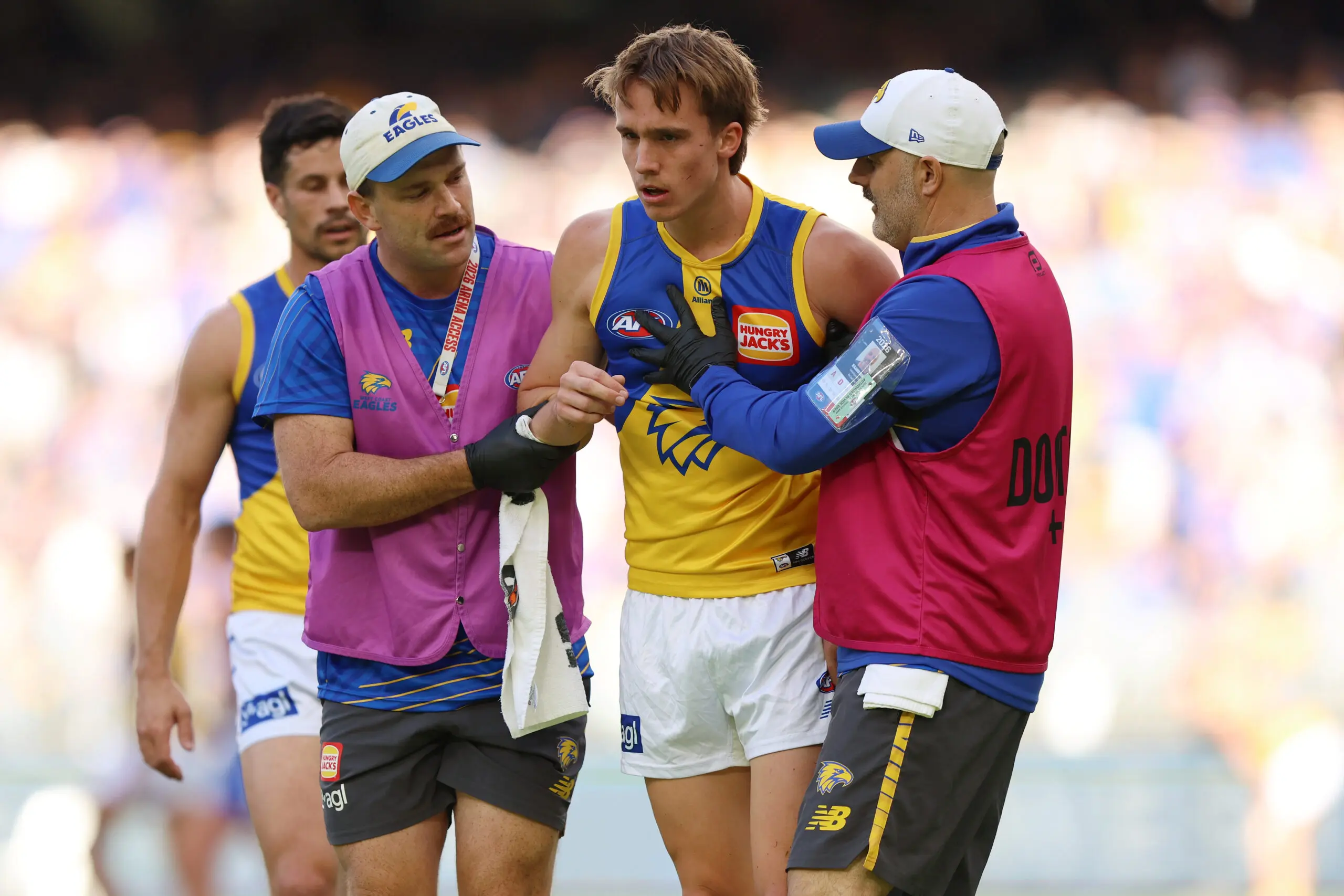 PERTH, AUSTRALIA - JUNE 13: Hamish Davis of the Eagles is helped from the field during the round 14 AFL match between North Melbourne Kangaroos and West Coast Eagles at Optus Stadium, on June 13, 2026, in Perth, Australia. (Photo by Janelle St Pierre/AFL Photos/via Getty Images)
