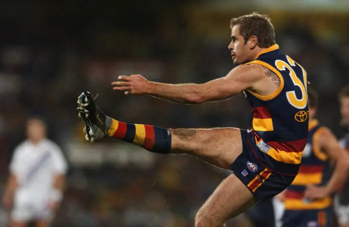 ADELAIDE- JULY 11:  Mark Ricciuto #32 of the Crows  kicks for goal during the round 15 AFL match between the Adelaide Crows and the Essendon Bombers at AAMI Stadium  July 11, 2003 in Adelaide, Australia. (Photo by Ryan Pierse/Getty Images)