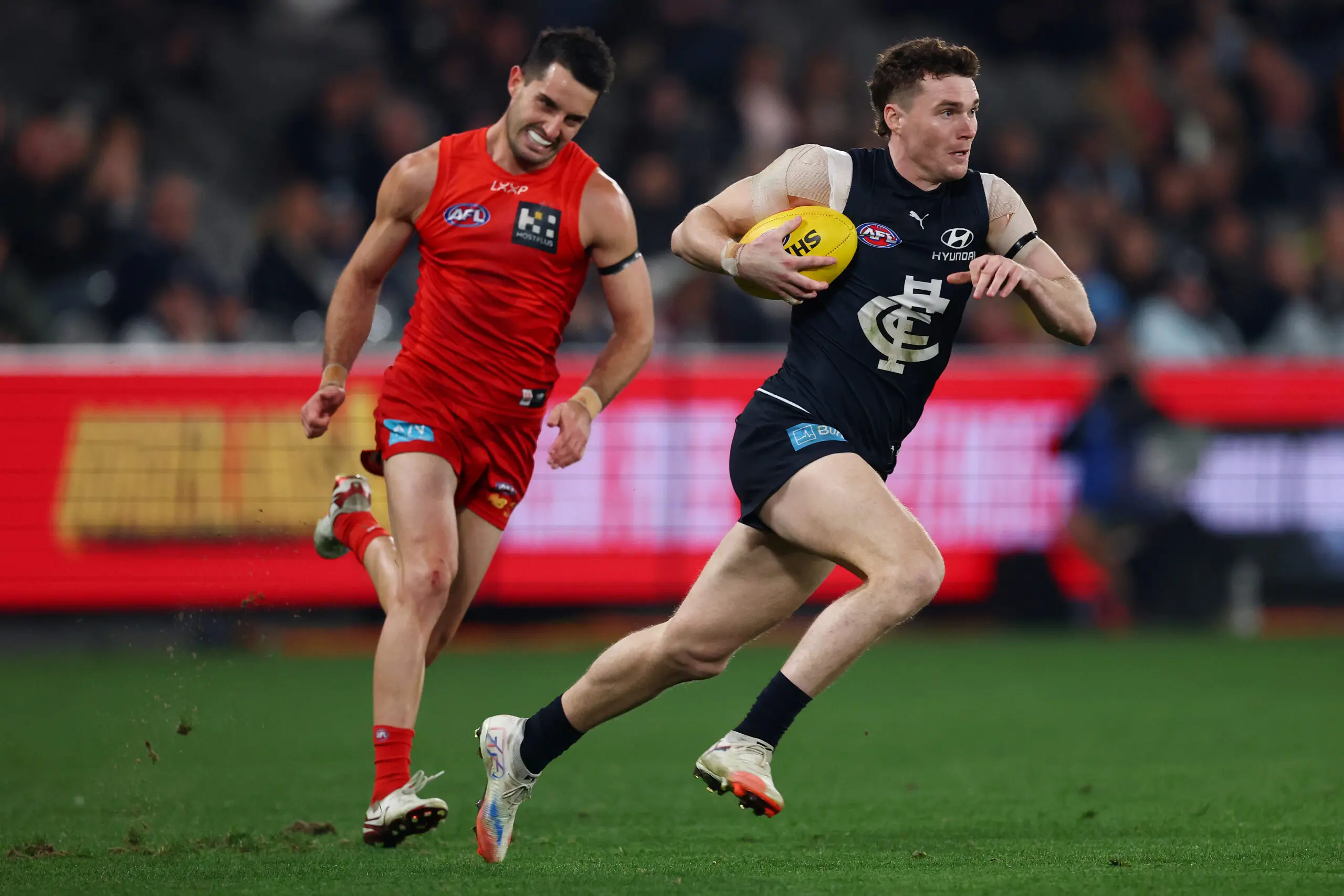 MELBOURNE, AUSTRALIA - AUGUST 09: Blake Acres of the Blues runs with the ball during the round 22 AFL match between Carlton Blues and Gold Coast Suns at Marvel Stadium on August 09, 2025 in Melbourne, Australia. (Photo by Morgan Hancock/Getty Images)