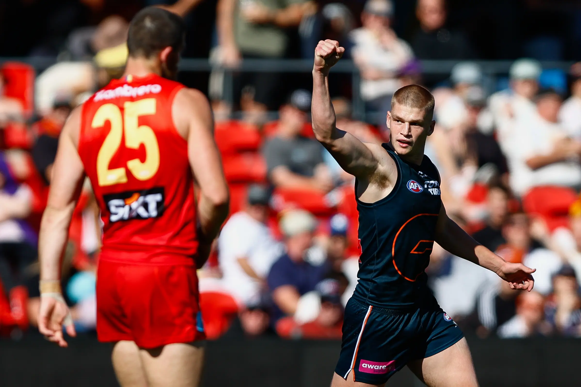 GOLD COAST , AUSTRALIA - AUGUST 16: Max Gruzewski of the Giants celebrates a goal during the 2025 AFL Round 23 match between the Gold Coast Suns and the GWS Giants at People First Stadium on August 16, 2025 in the Gold Coast, Australia. (Photo by Russell Freeman/AFL Photos via Getty Images)