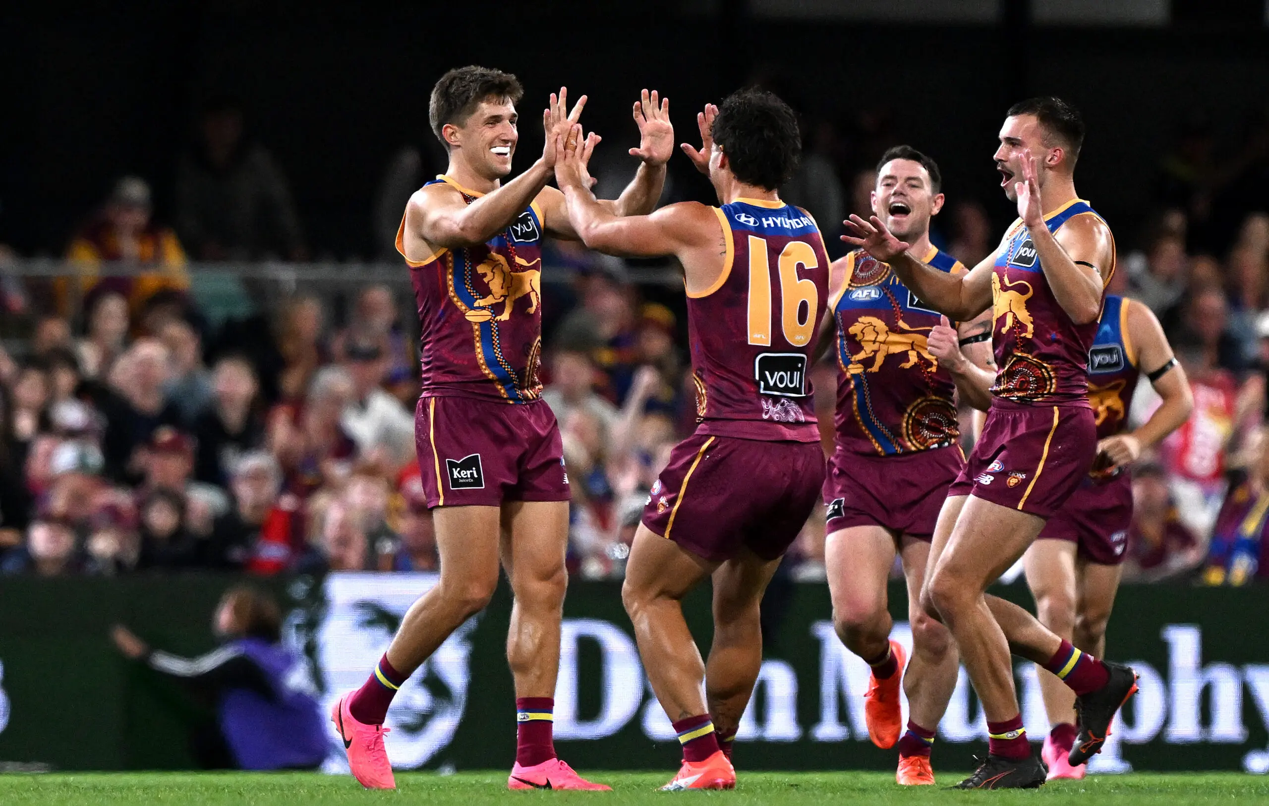 BRISBANE, AUSTRALIA - JULY 12: Zac Bailey of the Lions celebrates with team mates after kicking a goal during the round 18 AFL match between Brisbane Lions and Essendon Bombers at The Gabba, on July 12, 2026, in Brisbane, Australia. (Photo by Bradley Kanaris/Getty Images)