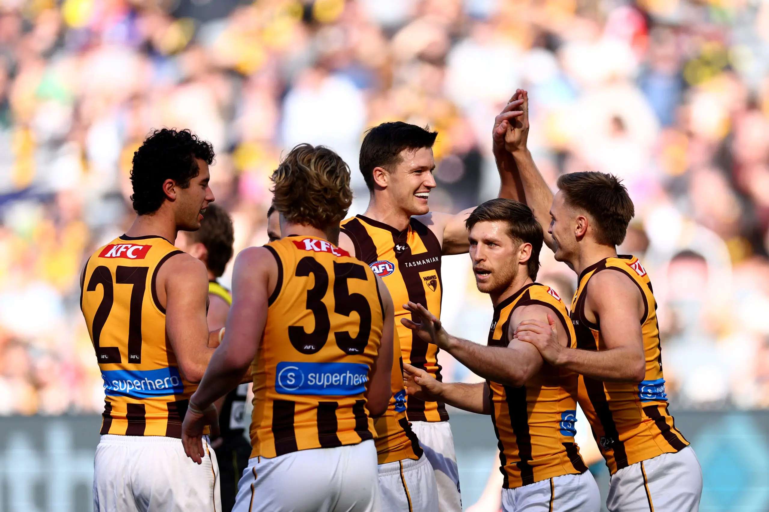 MELBOURNE, AUSTRALIA - JULY 19: Mitch Lewis of the Hawks is congratulated by team mates after kicking a goal during the round 19 AFL match between Richmond Tigers and Hawthorn Hawks at Melbourne Cricket Ground, on July 19, 2026, in Melbourne, Australia. (Photo by Josh Chadwick/Getty Images)