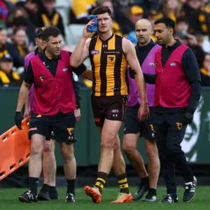 MELBOURNE, AUSTRALIA - JULY 25: Mitch Lewis of the Hawks leaves the field with trainers during the round 20 AFL match between Hawthorn Hawks and Essendon Bombers at Melbourne Cricket Ground, on July 25, 2026, in Melbourne, Australia. (Photo by Daniel Pockett/Getty Images)