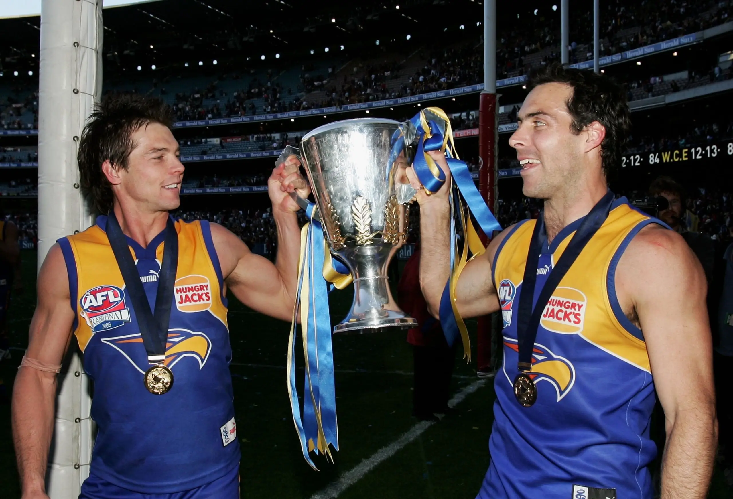 MELBOURNE, AUSTRALIA - SEPTEMBER 30: Ben Cousins and Drew Banfield of the Eagles celebrate with the trophy after the AFL Grand Final match between the Sydney Swans and the West Coast Eagles at the Melbourne Cricket Ground on September 30, 2006 in Melbourne, Australia. (Photo by Hamish Blair/Getty Images)