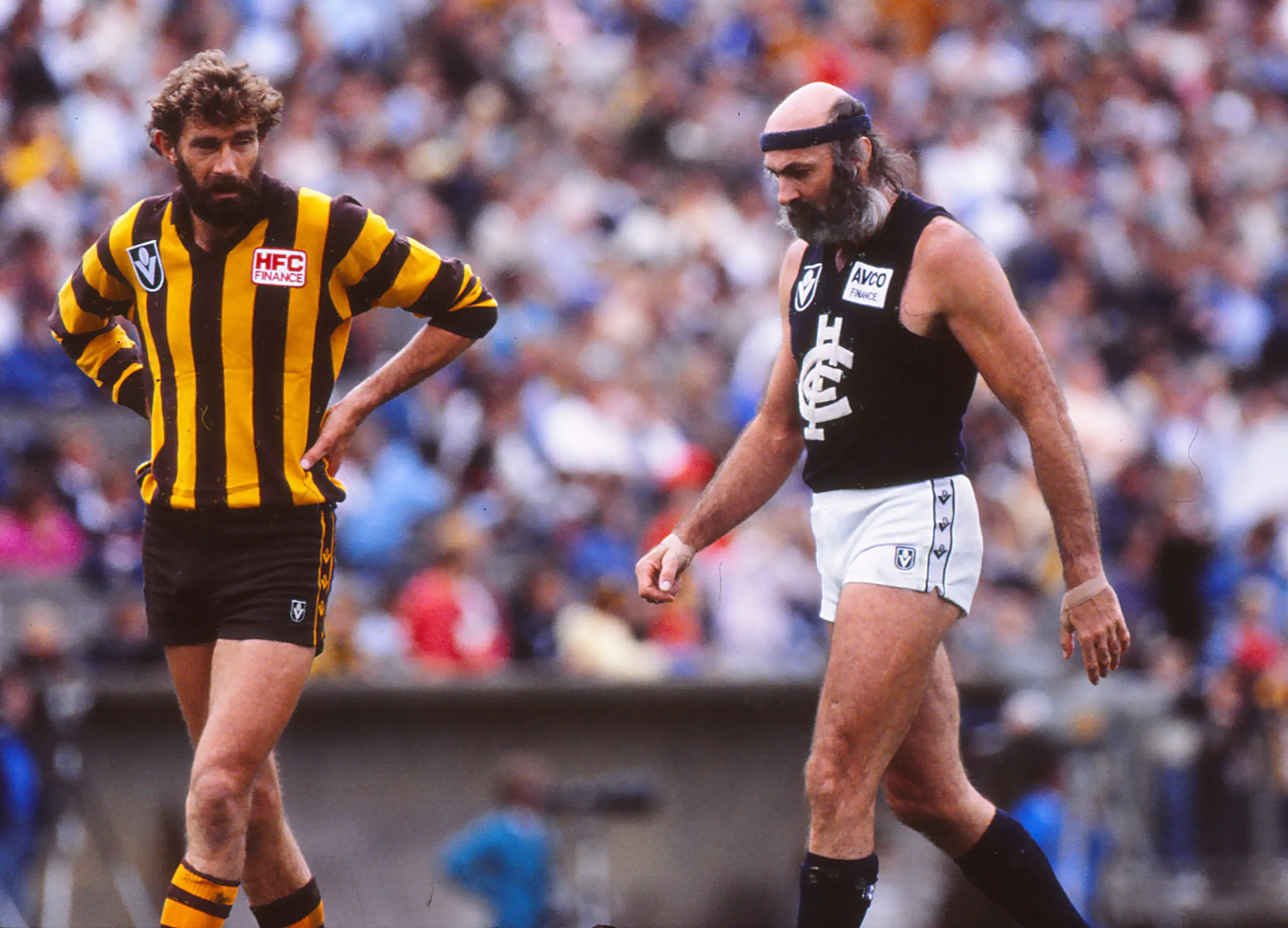 MELBOURNE, AUSTRALIA - AUGUST 01: Michael Tuck (L) of the Hawks and Bruce Doull of the Blues walk on field during a VFL match between the Hawthorn Hawks and the Carlton Blues on August 1, 1990 in Melbourne, Australia. (Photo by Getty Images)