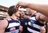 MELBOURNE, AUSTRALIA - SEPTEMBER 24: Cats head coach Chris Scott celebrates with Gryan Miers of the Cats and Jake Kolodjashnij of the Cats after winning the 2022 AFL Grand Final match between the Geelong Cats and the Sydney Swans at the Melbourne Cricket Ground on September 24, 2022 in Melbourne, Australia. (Photo by Cameron Spencer/AFL Photos/via Getty Images)