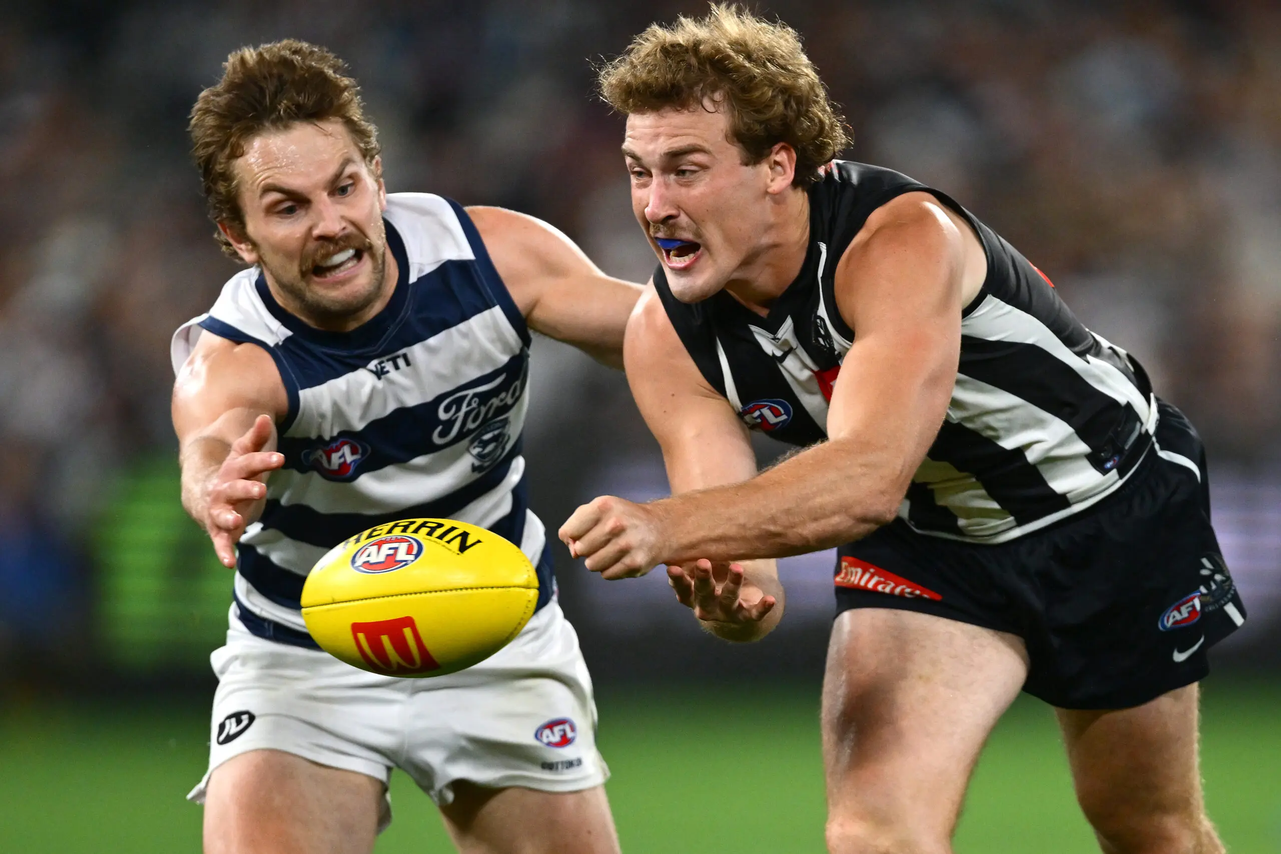 MELBOURNE, AUSTRALIA - MAY 09: Angus Anderson of the Magpies handballs whilst being tackled by Tom Atkins of the Cats during the round nine AFL match between Geelong Cats and Collingwood Magpies at Melbourne Cricket Ground, on May 09, 2026, in Melbourne, Australia. (Photo by Quinn Rooney/Getty Images)