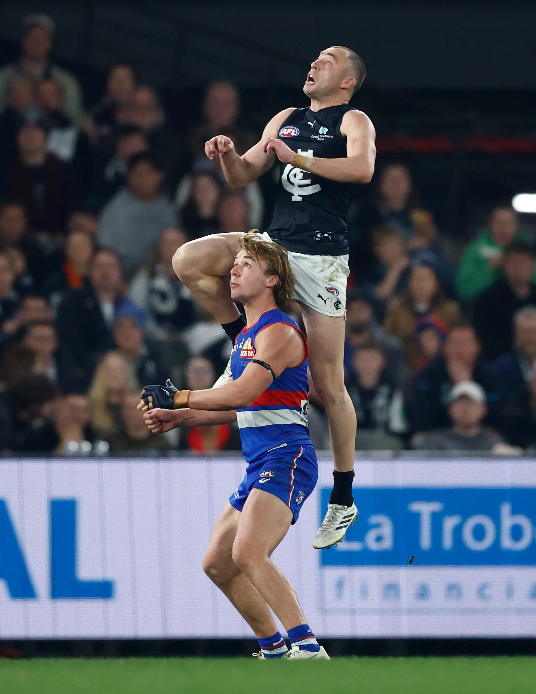 MELBOURNE, AUSTRALIA - AUGUST 16: Will Hayward of the Blues takes a spectacular mark over Ryley Sanders of the Bulldogs during the 2026 AFL Round 23 match between the Western Bulldogs and the Carlton Blues at Marvel Stadium on August 16, 2026 in Melbourne, Australia. (Photo by Michael Willson/AFL Photos via Getty Images)