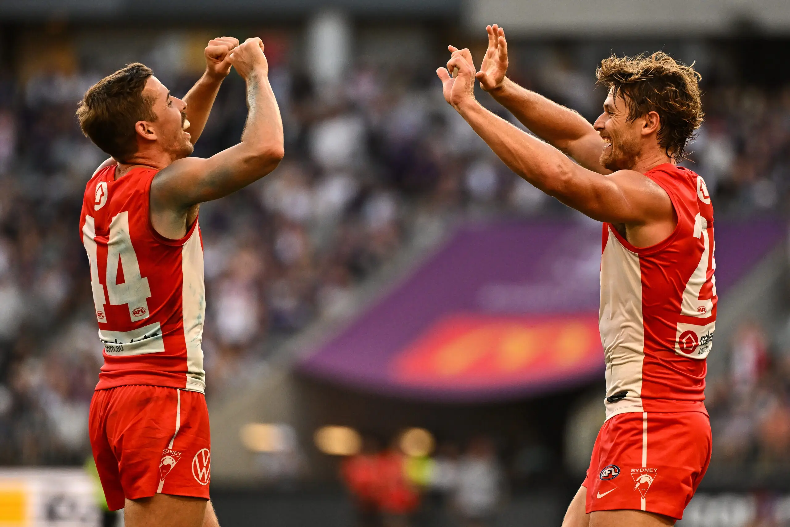 PERTH, AUSTRALIA - MARCH 23: Jake Lloyd and Dane Rampe of the Swans celebrate the win on the siren during the 2025 AFL Round 02 match between the Fremantle Dockers and the Sydney Swans at Optus Stadium on March 23, 2025 in Perth, Australia. (Photo by Daniel Carson/AFL Photos via Getty Images)